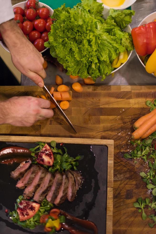 top view of Chef hands preparing beef steak photo