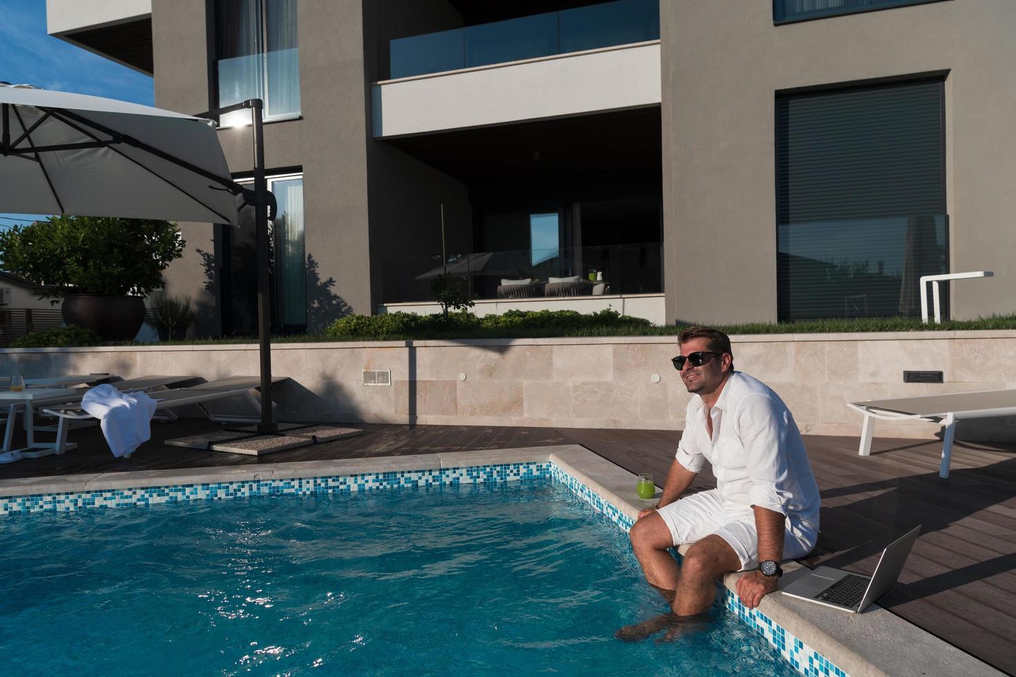 A modern senior man in casual clothes enjoys a vacation in an expensive house. Selective focus photo