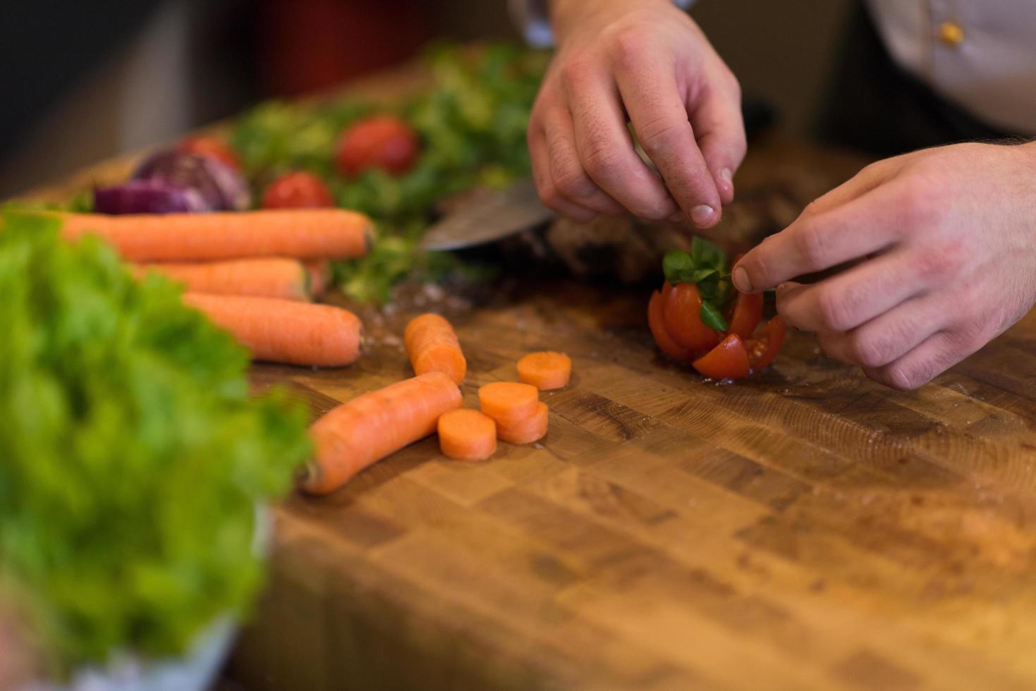 closeup of Chef hands preparing beef steak photo