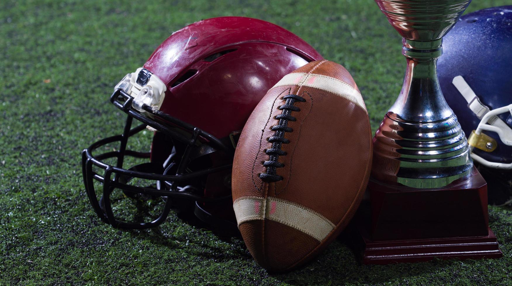 closeup of american football,helmets and trophy photo