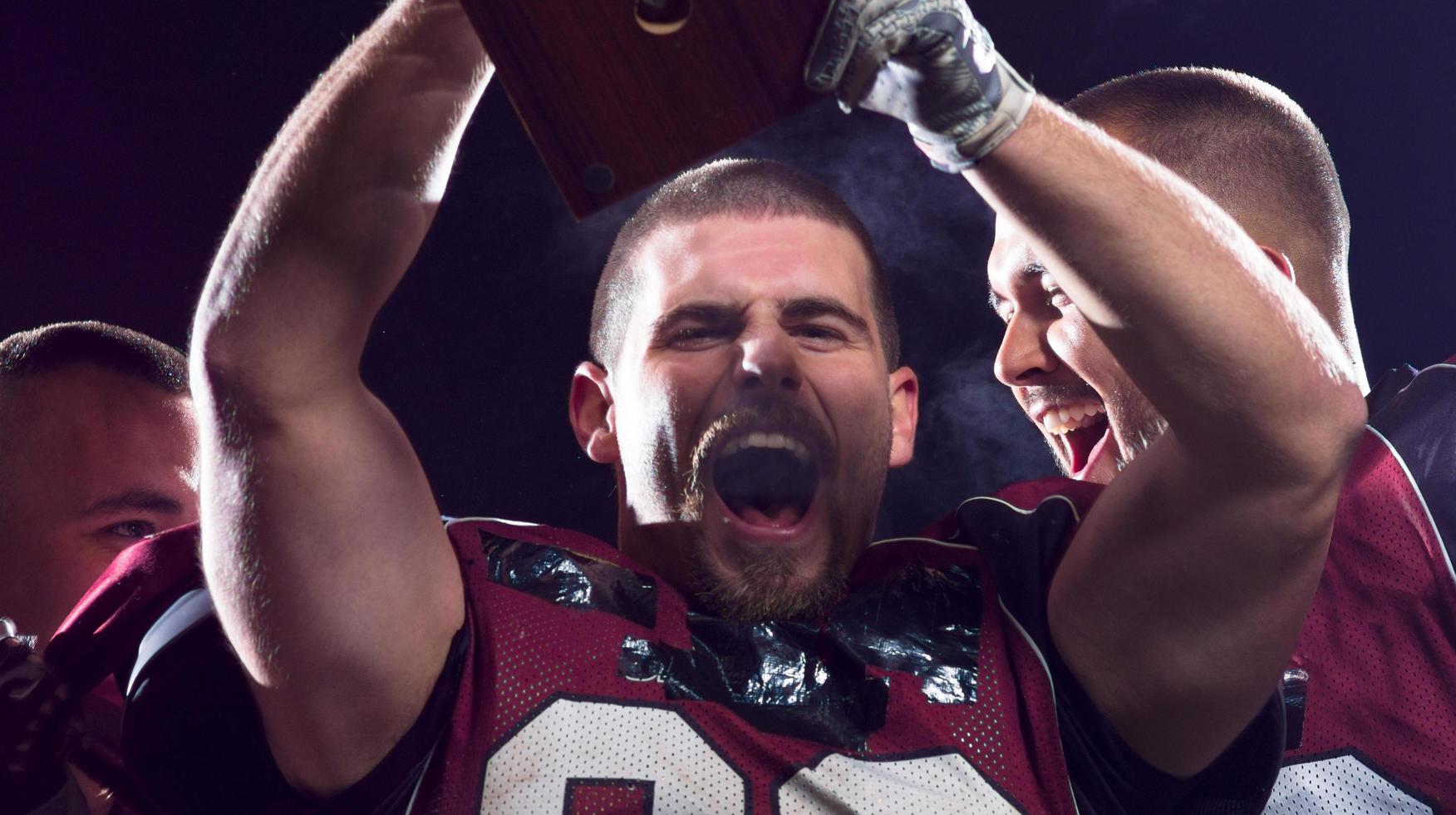 american football team celebrating victory photo