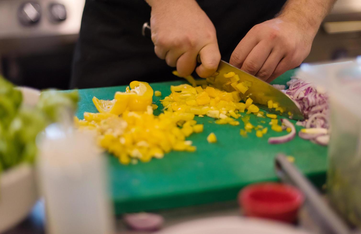 Chef cutting fresh and delicious vegetables photo