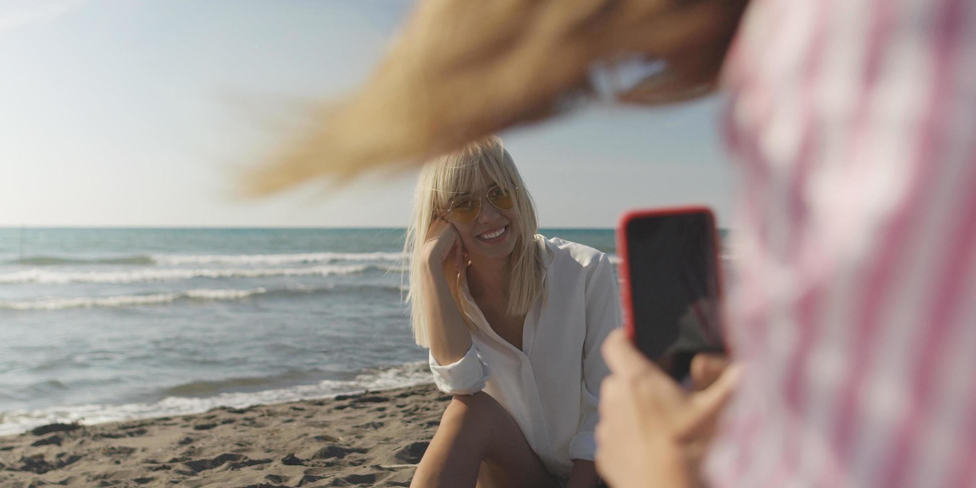 Two girl friends having fun photographing each other on vecation photo