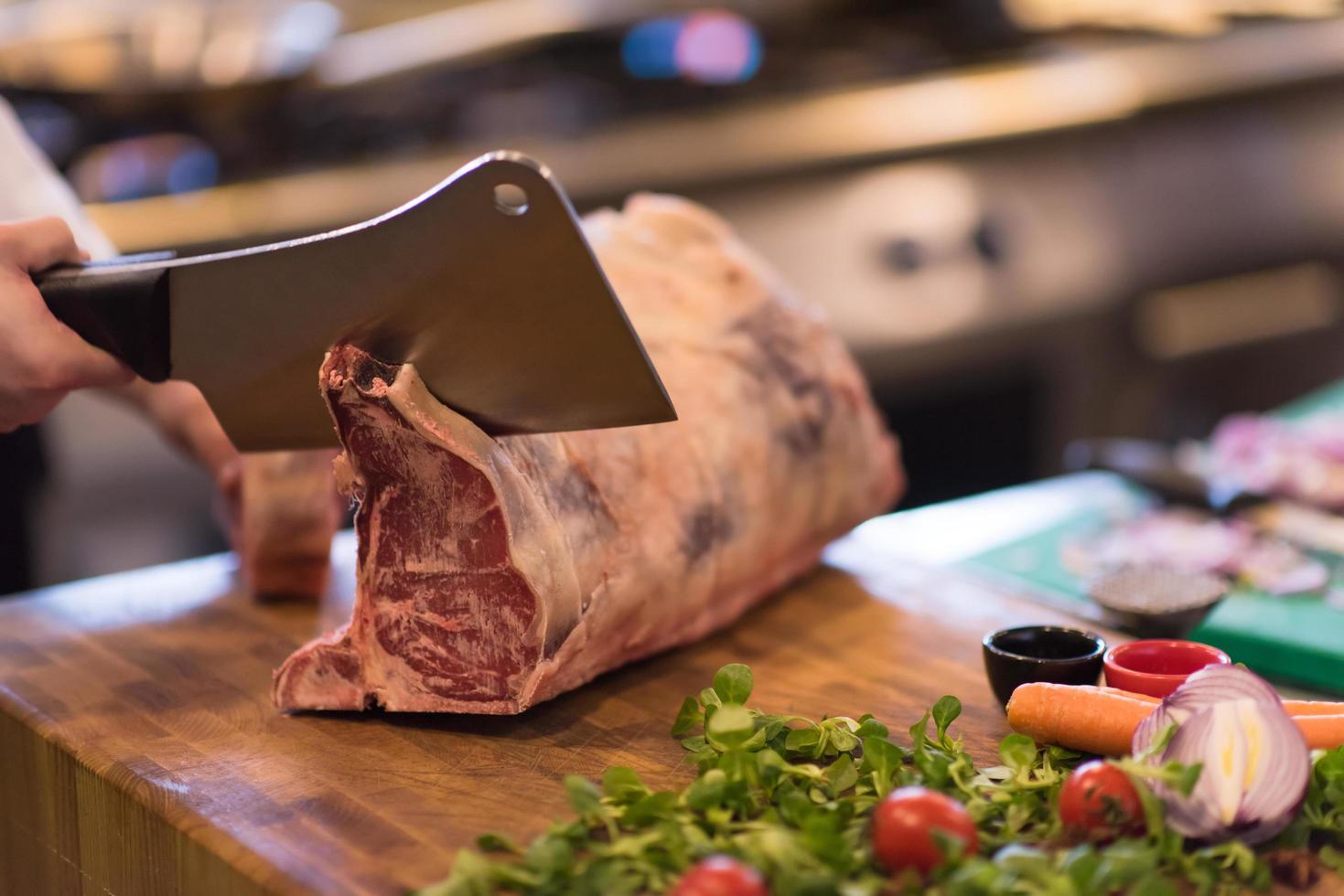 chef cutting big piece of beef photo