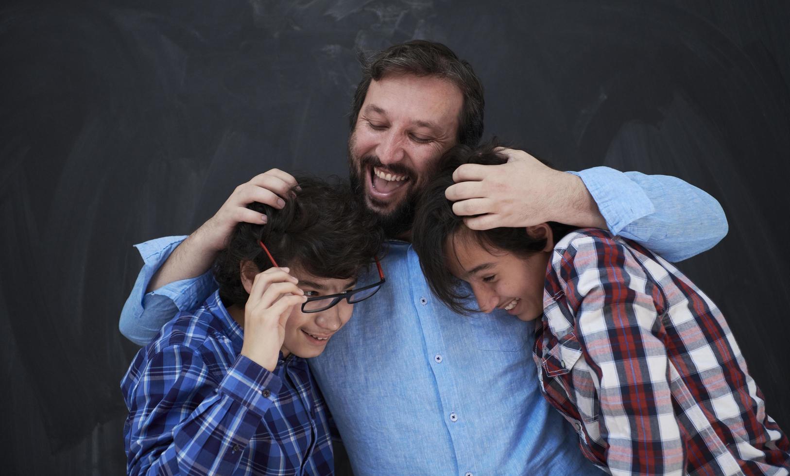 happy father hugging sons photo