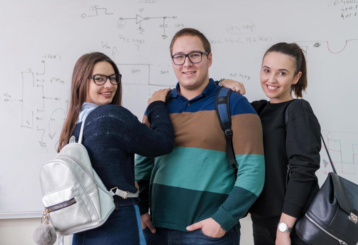 portrait of young students in front of chalkboard photo