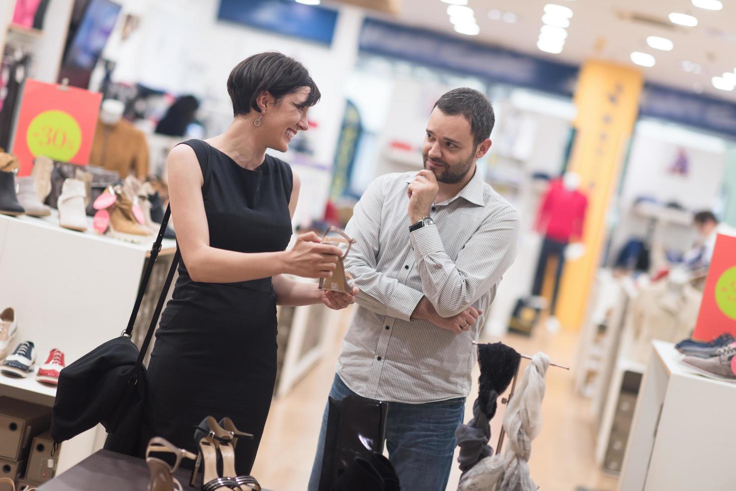 couple chooses shoes At Shoe Store photo