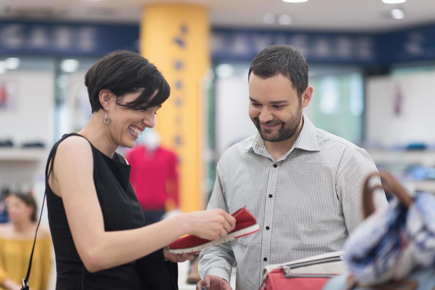 couple chooses shoes At Shoe Store photo