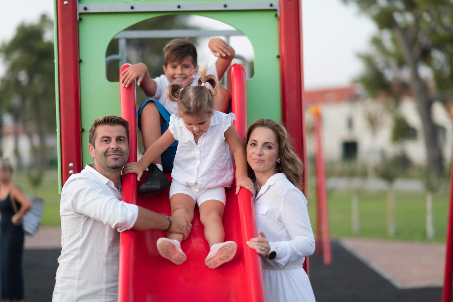 Senior couple in casual clothes with their children spending time in park a vacation together. Family time . Selective focus photo