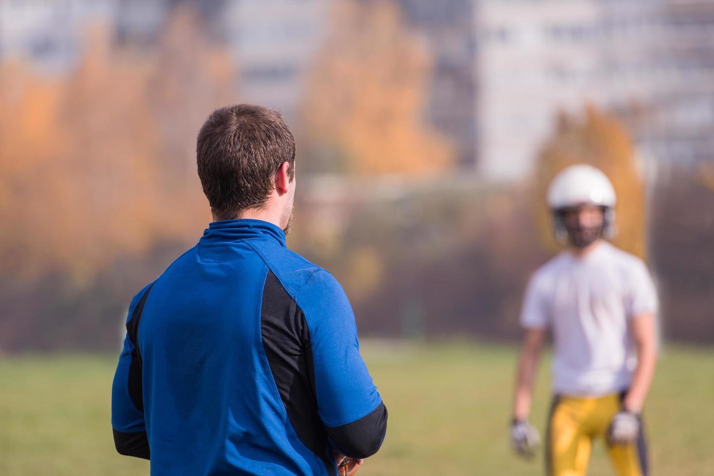 american football team with coach in action photo