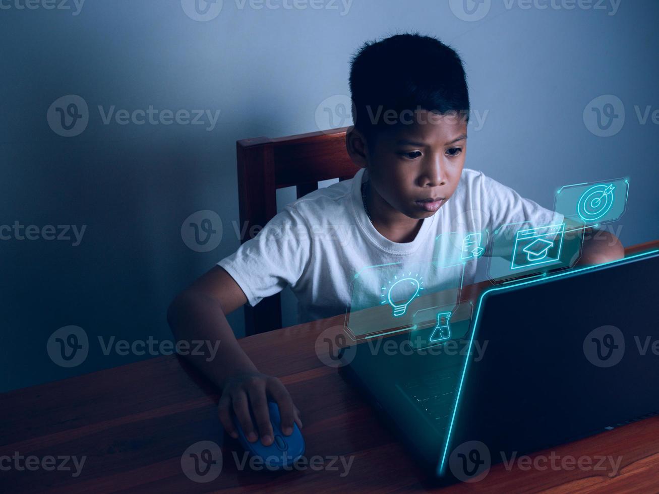 Education concept image. Creative idea and innovation. boy sitting staring at computer and there is an educational icon on the front. photo