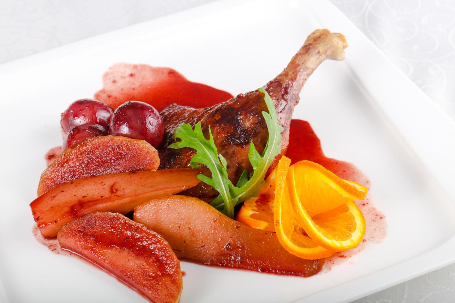 Duck leg on the plate and white background photo