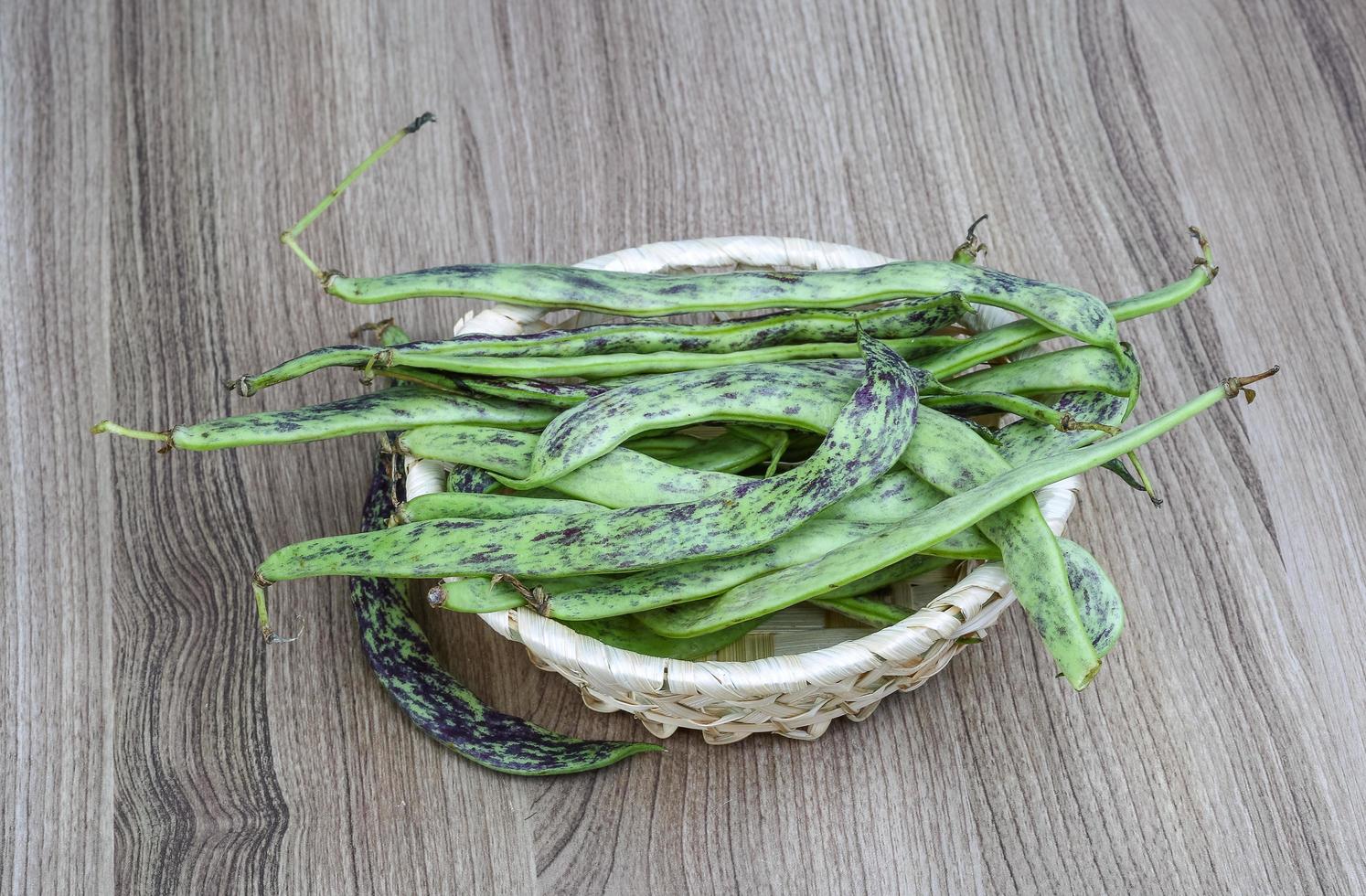 Green beans on wood photo