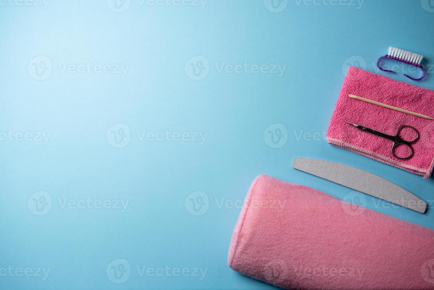 Top view of manicure and pedicure equipment on blue background photo