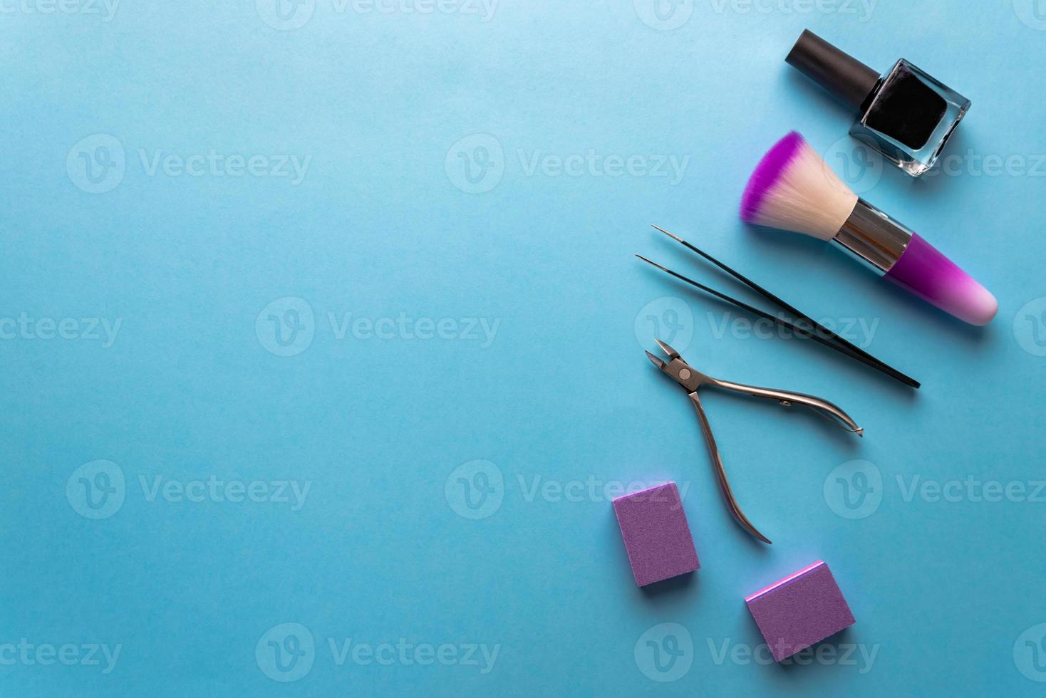 Top view of manicure and pedicure equipment on blue background photo