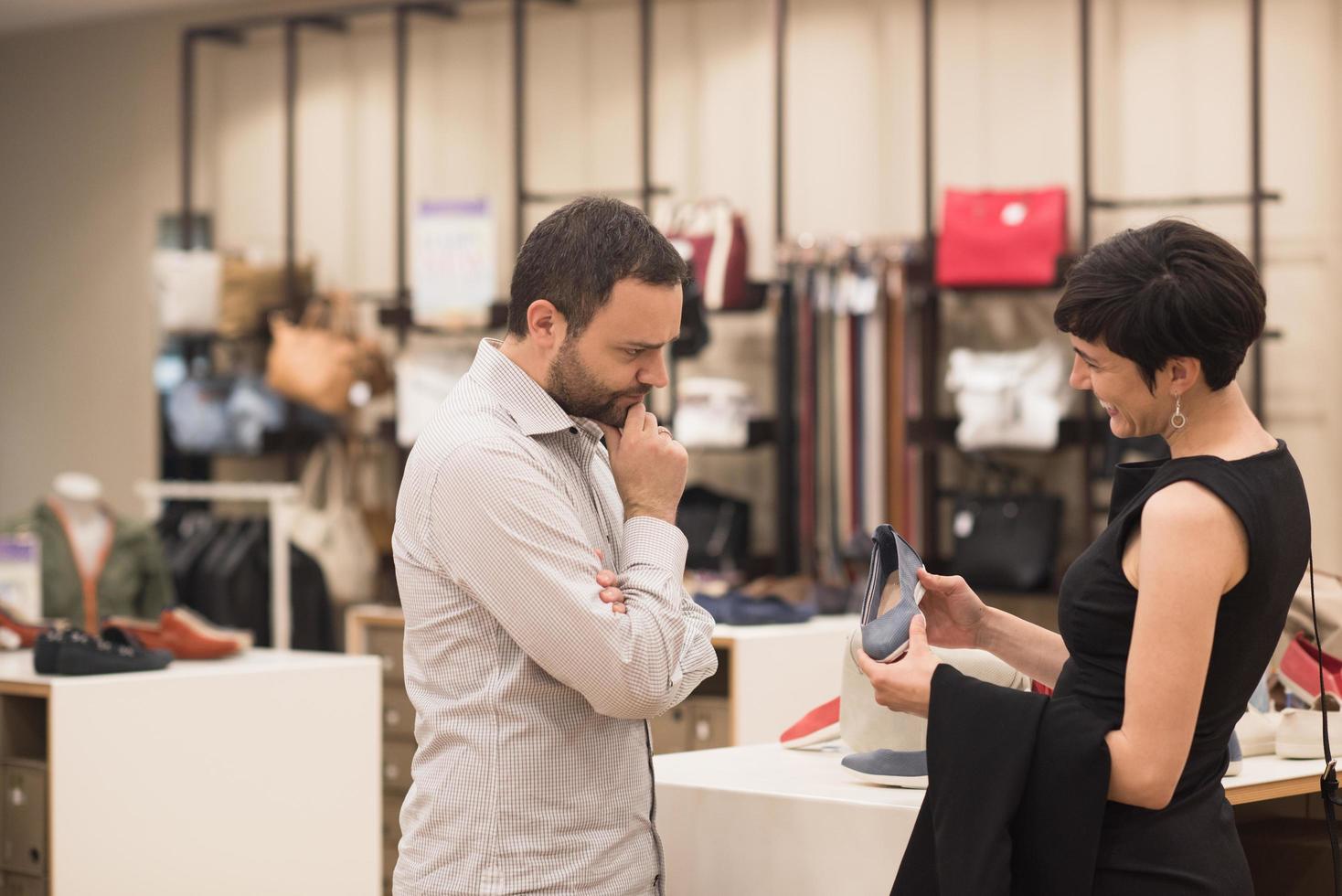 couple chooses shoes At Shoe Store photo