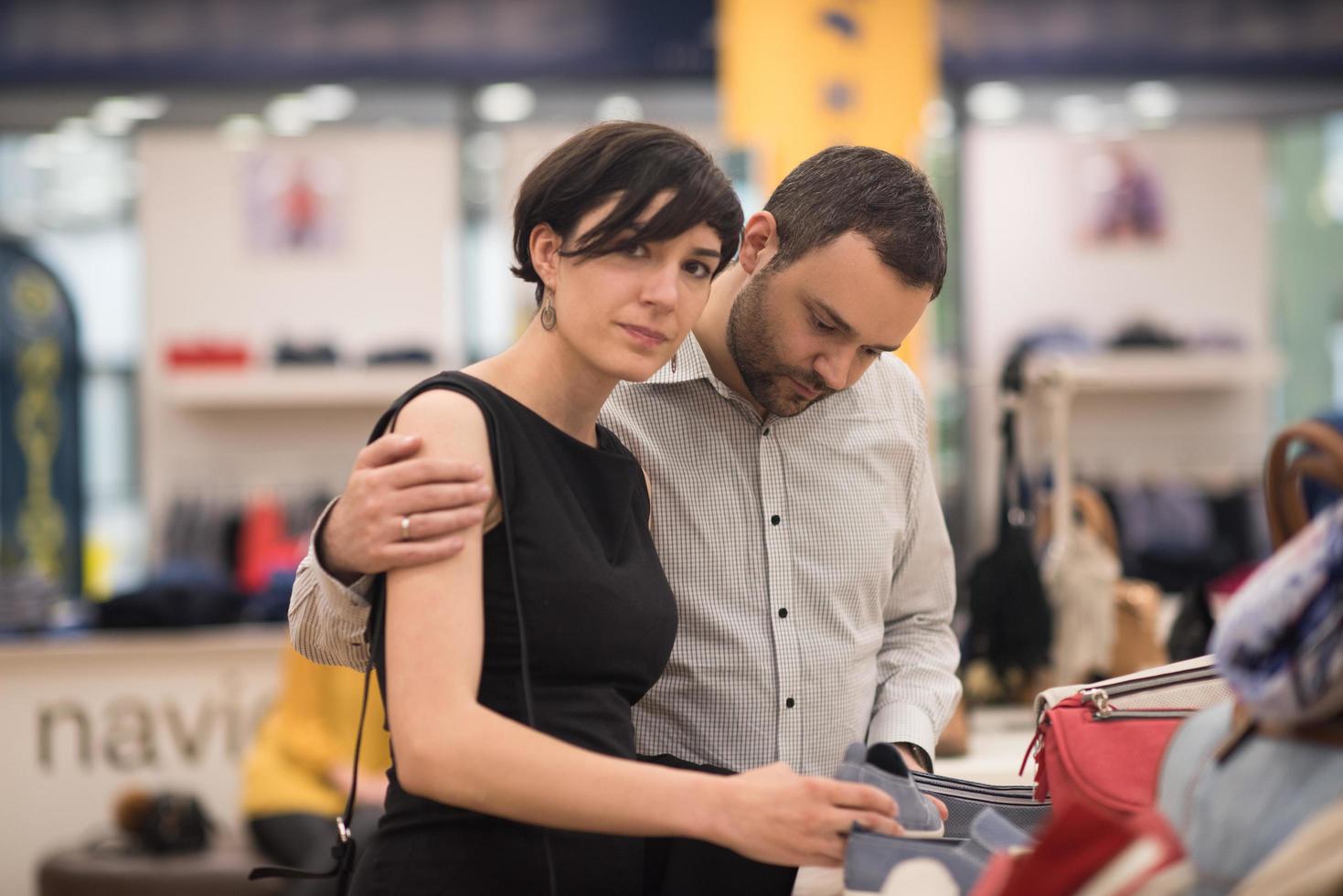 couple chooses shoes At Shoe Store photo