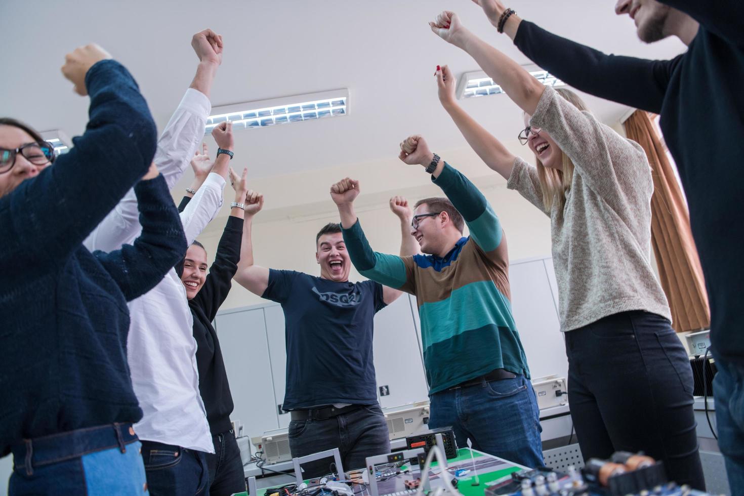 students celebrating successfully finished project photo