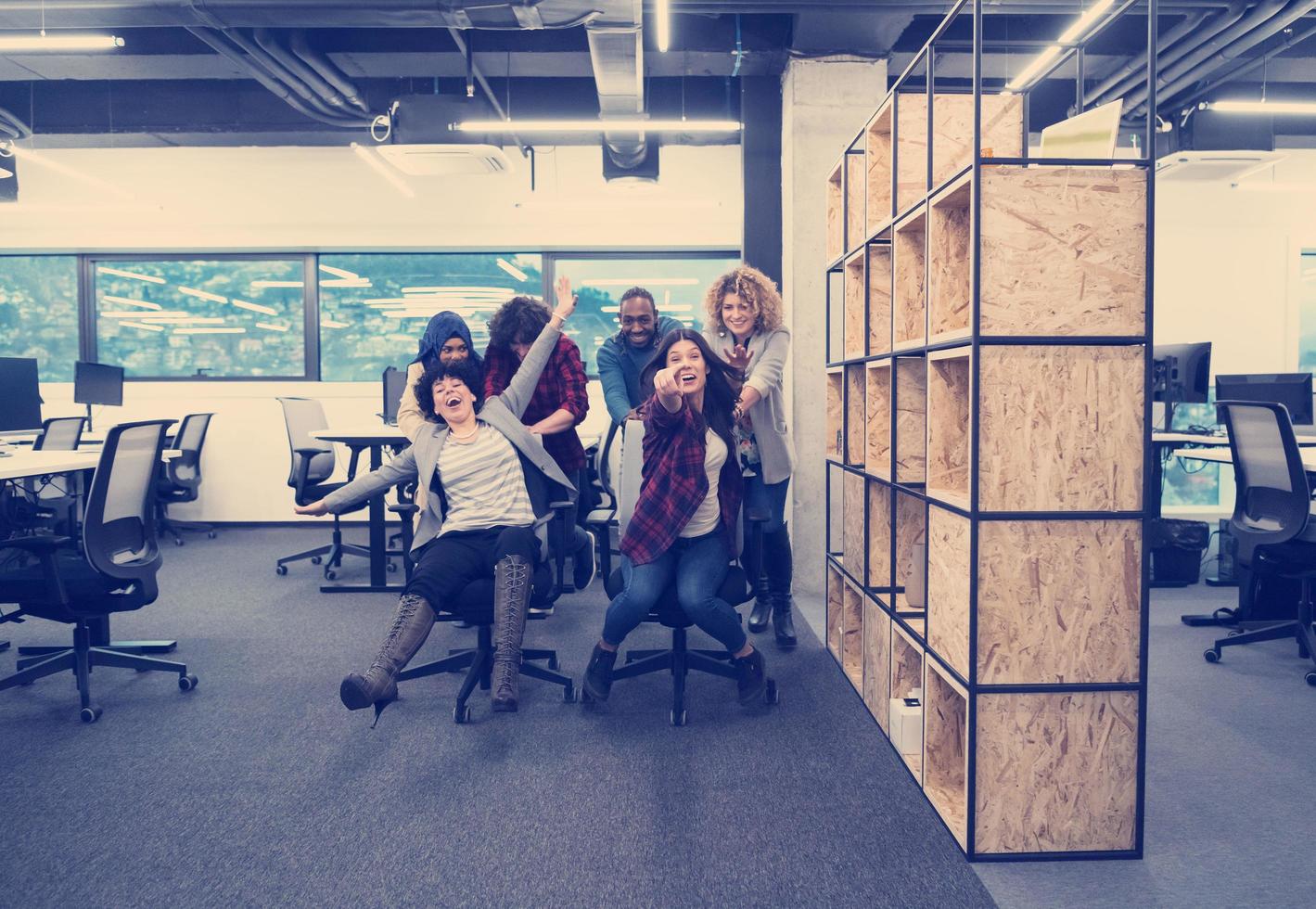 multiethnics business team racing on office chairs photo