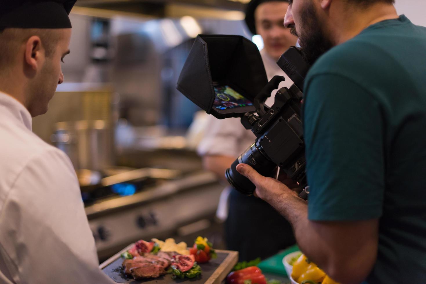 videographer recording while team cooks and chefs preparing meal photo