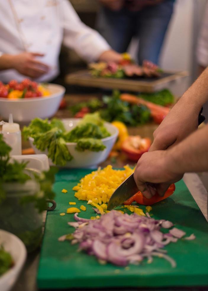 Chef cutting fresh and delicious vegetables photo