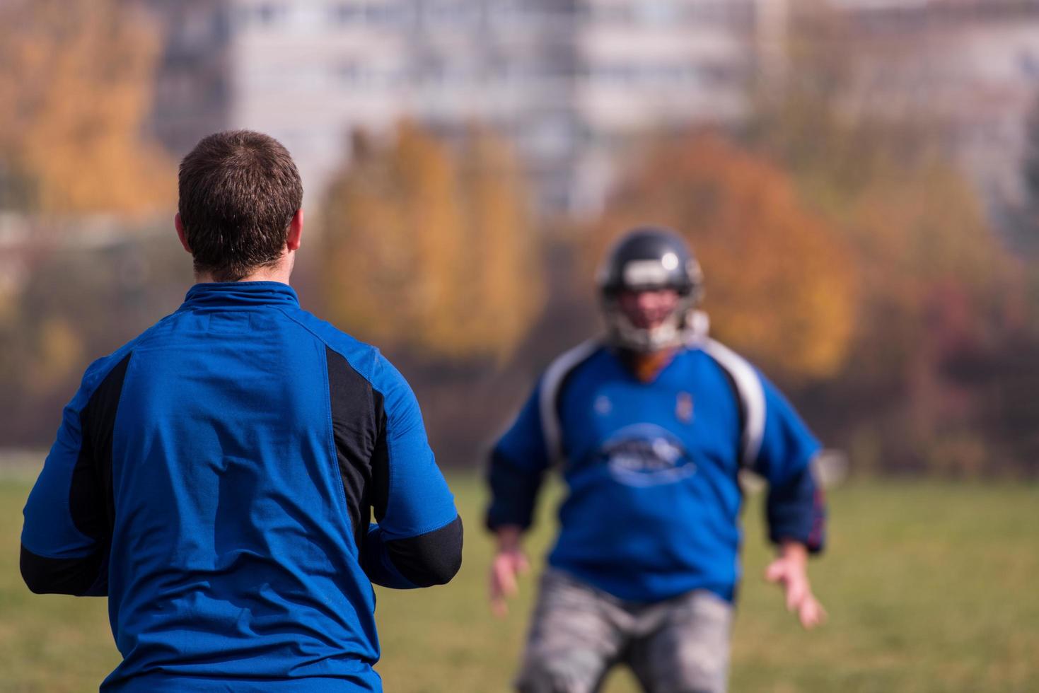 american football team with coach in action photo