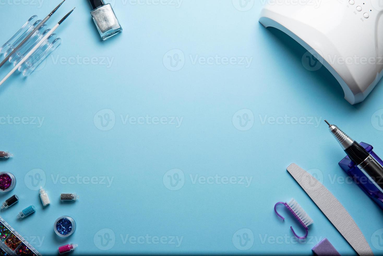 Top view of manicure and pedicure equipment on blue background photo