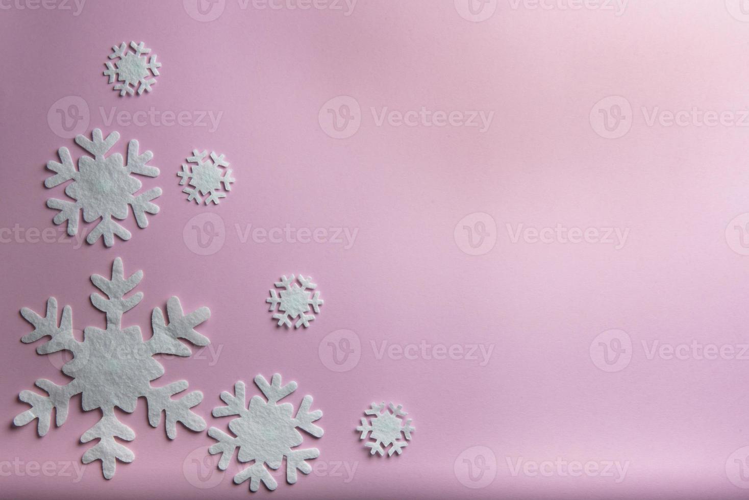 Christmas or winter composition. Pattern made of snowflakes on pastel pink background. photo