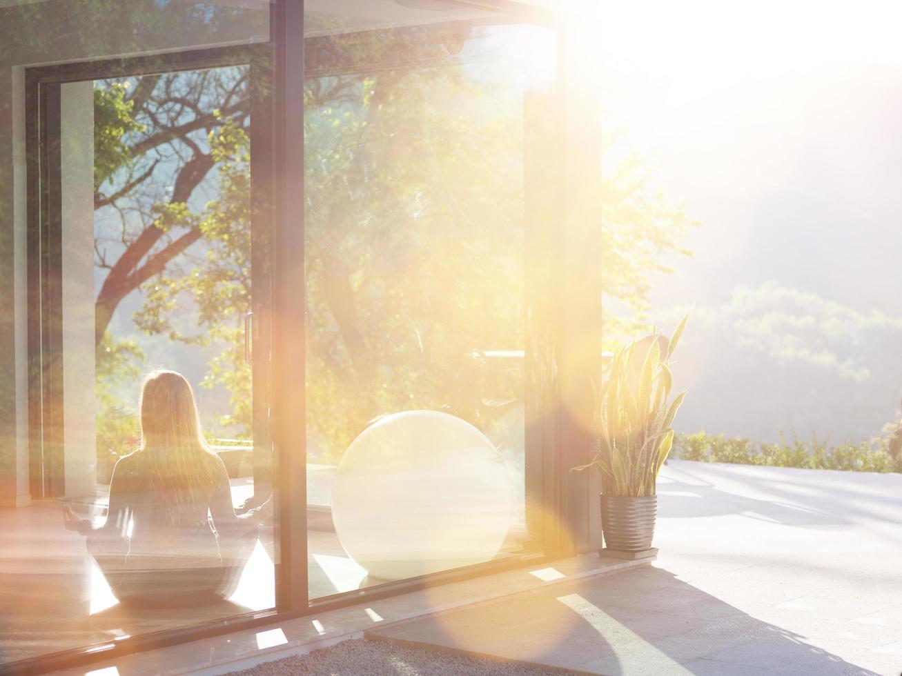 young woman doing morning yoga exercises photo