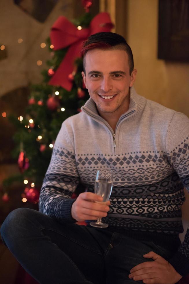 Happy young man with a glass of champagne photo