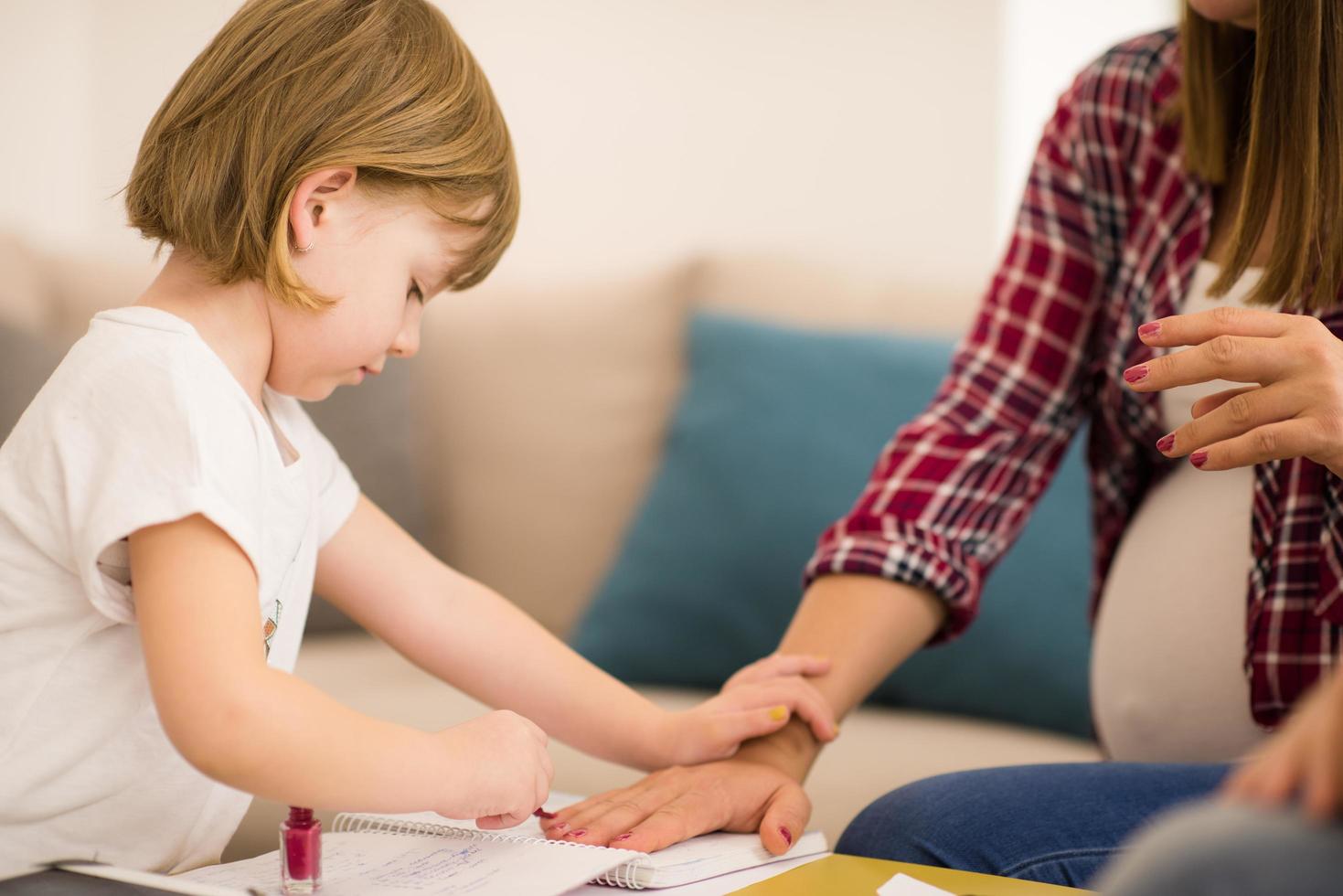 daughter painting nails to her pregnant mom 12719728 Stock Photo at