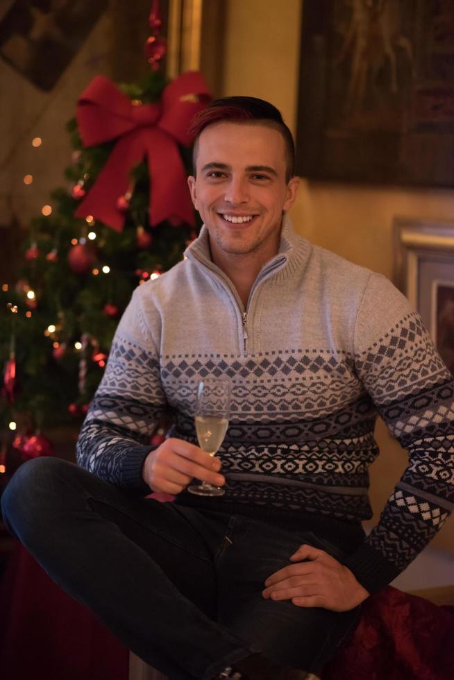 Happy young man with a glass of champagne photo