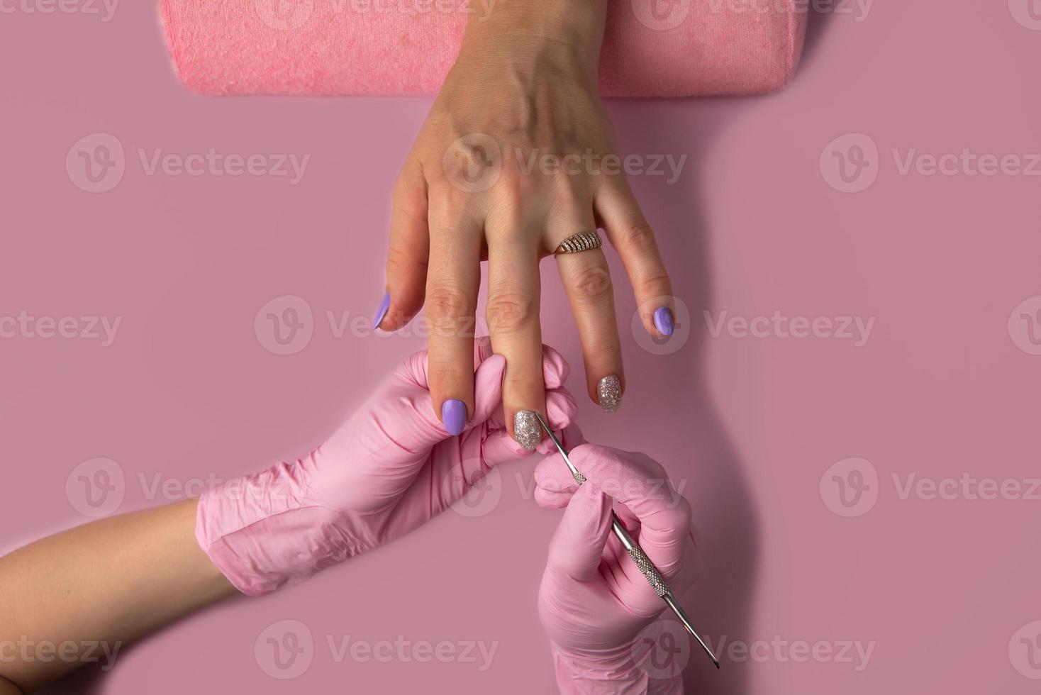 Manicure process on pink background, top view.Manicure in beauty salon.Manicure concept, photo