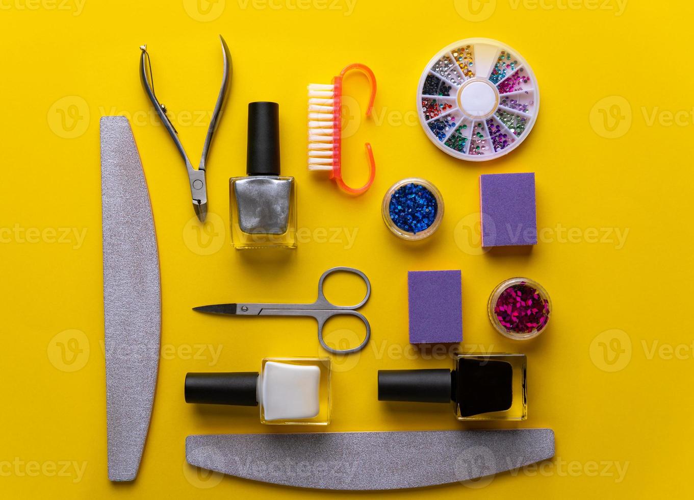 manicure and pedicure tools and accessories on yellow background top view. photo