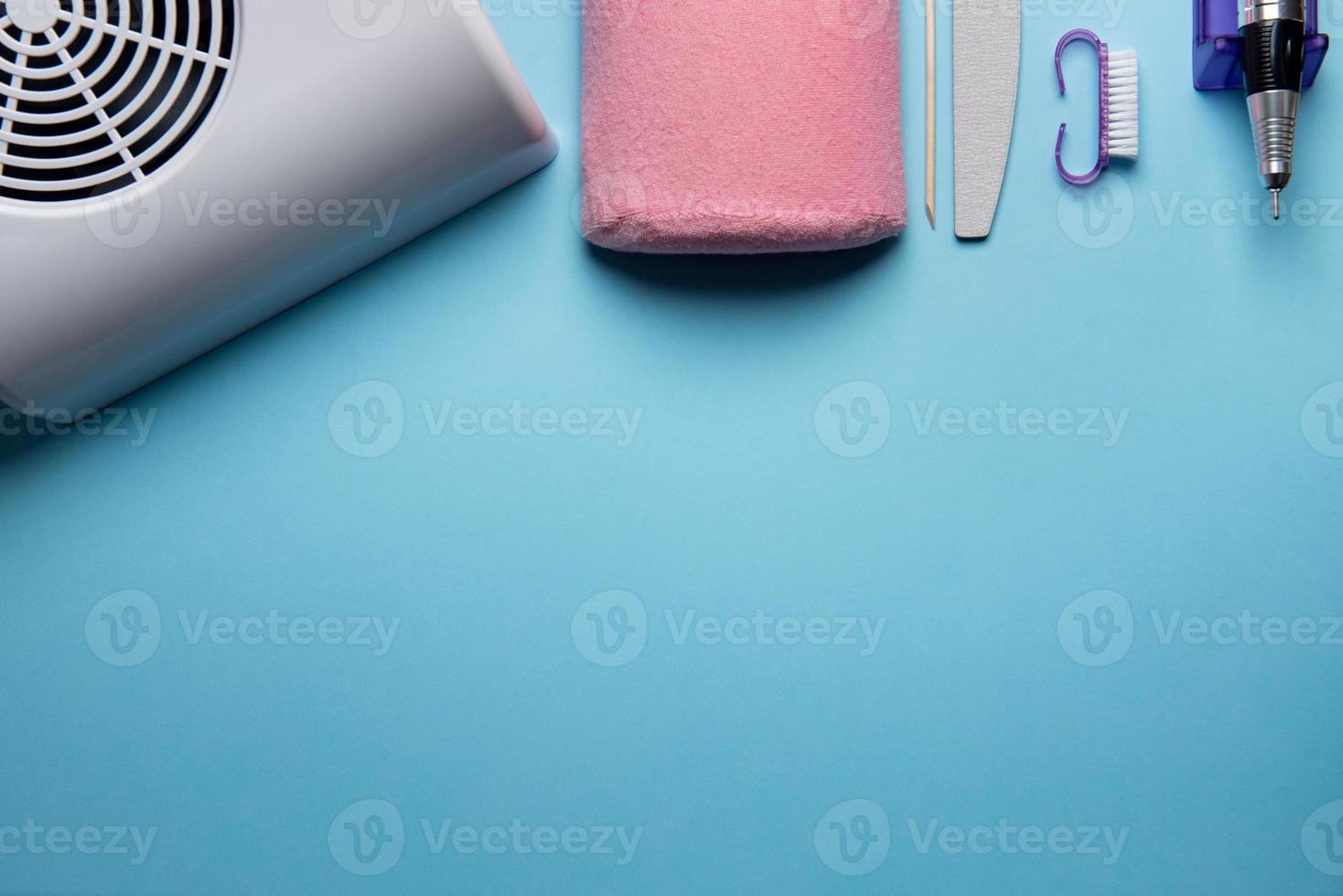 Top view of manicure and pedicure equipment on blue background photo