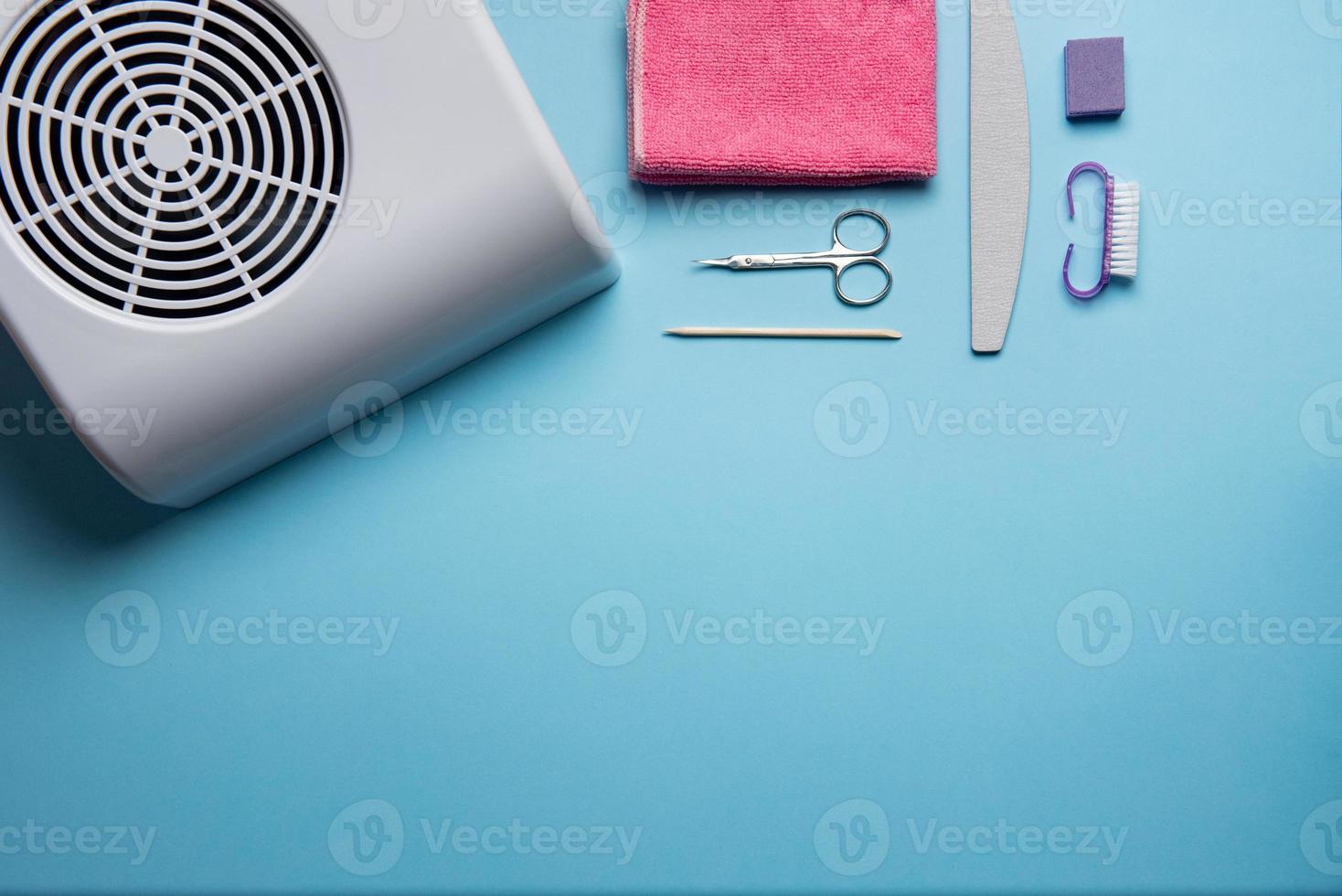 Top view of manicure and pedicure equipment on blue background photo