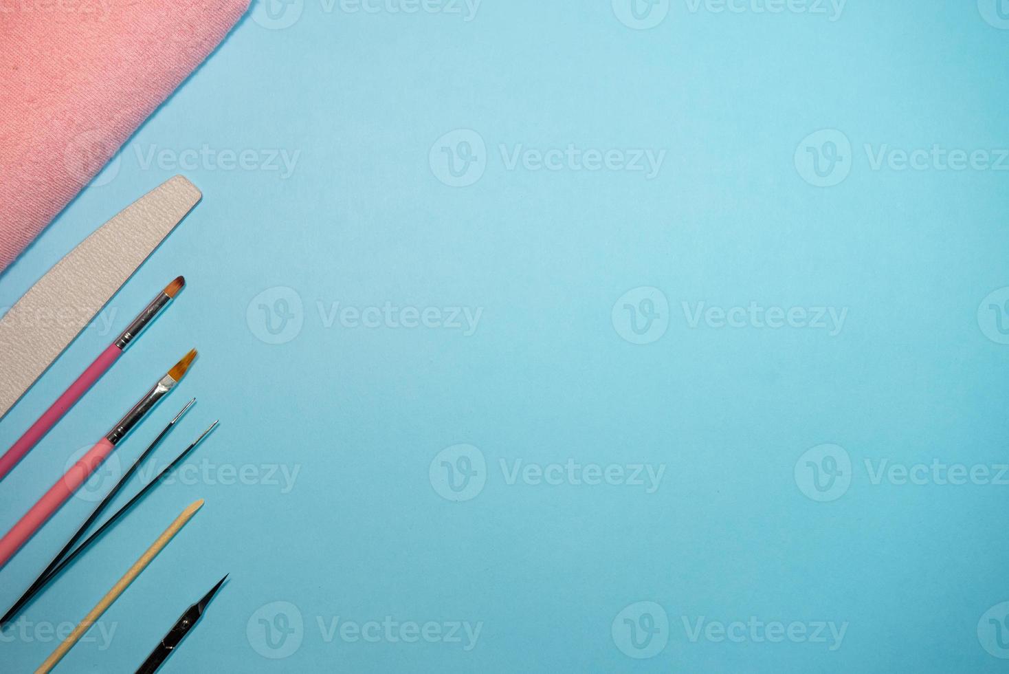 Top view of manicure and pedicure equipment on blue background photo