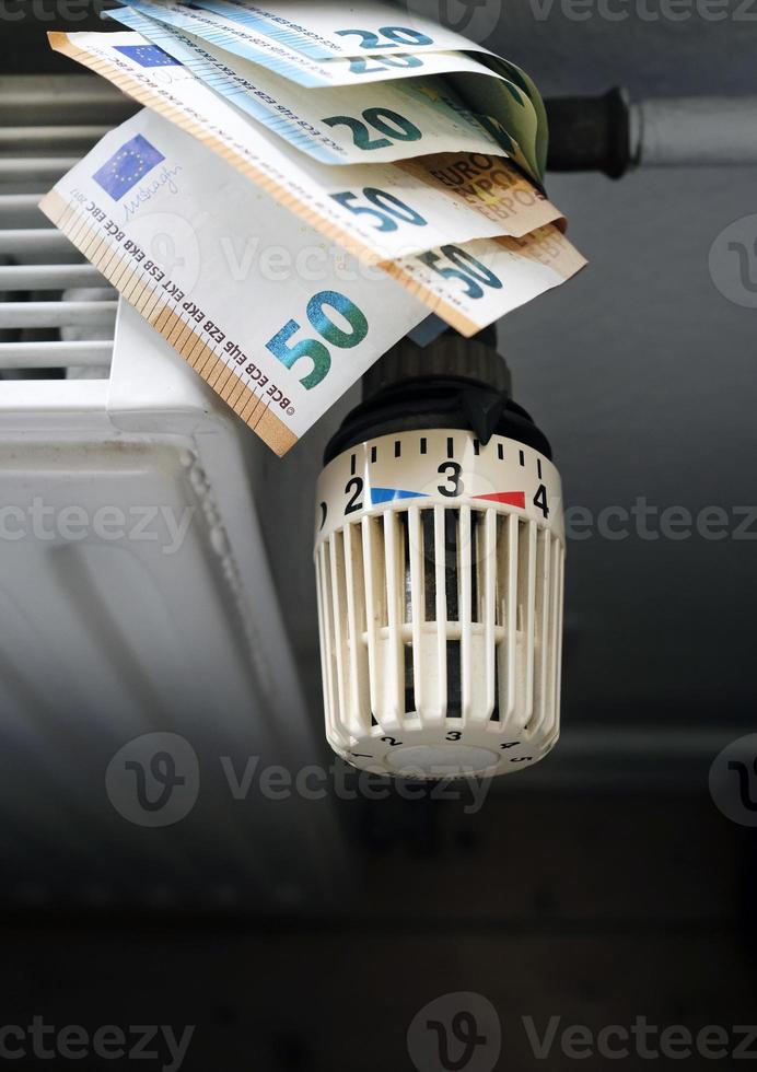 Controlling the heating costs - radiator control and Euro bills on the central heating photo