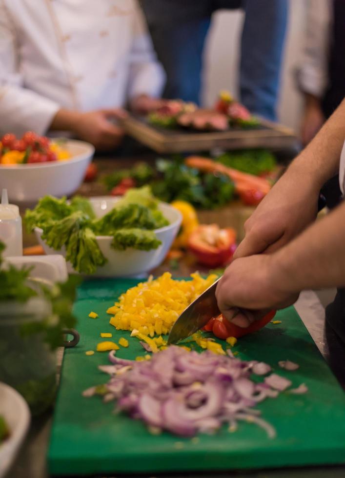 Chef cutting fresh and delicious vegetables photo