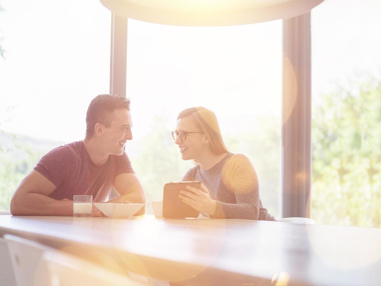 couple enjoying morning coffee and strawberries photo