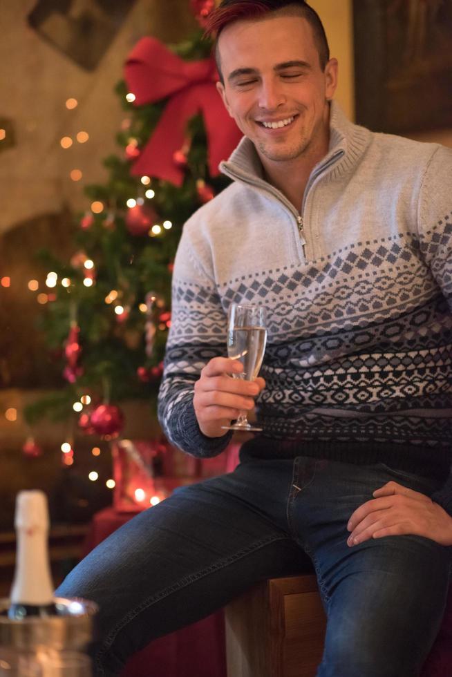 Happy young man with a glass of champagne photo