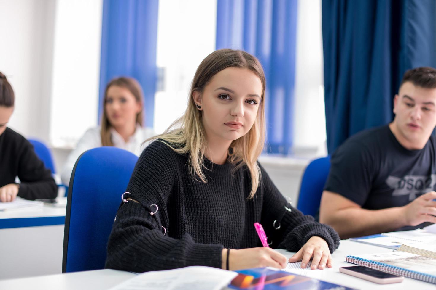 female student writing notes photo