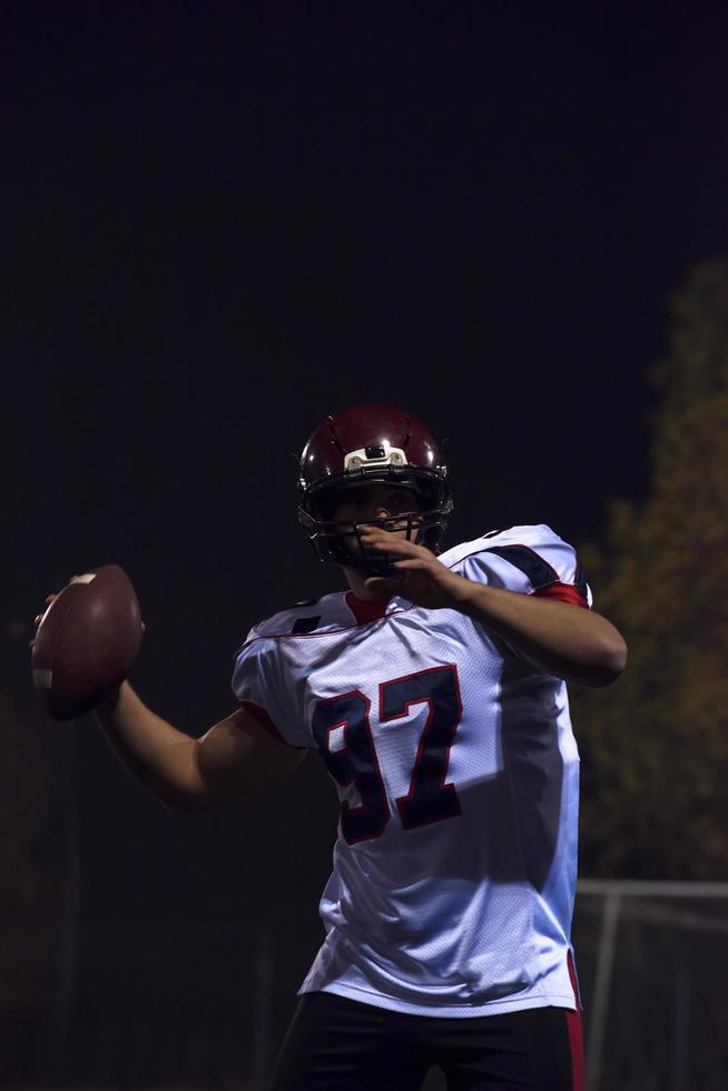 american football player throwing rugby ball photo