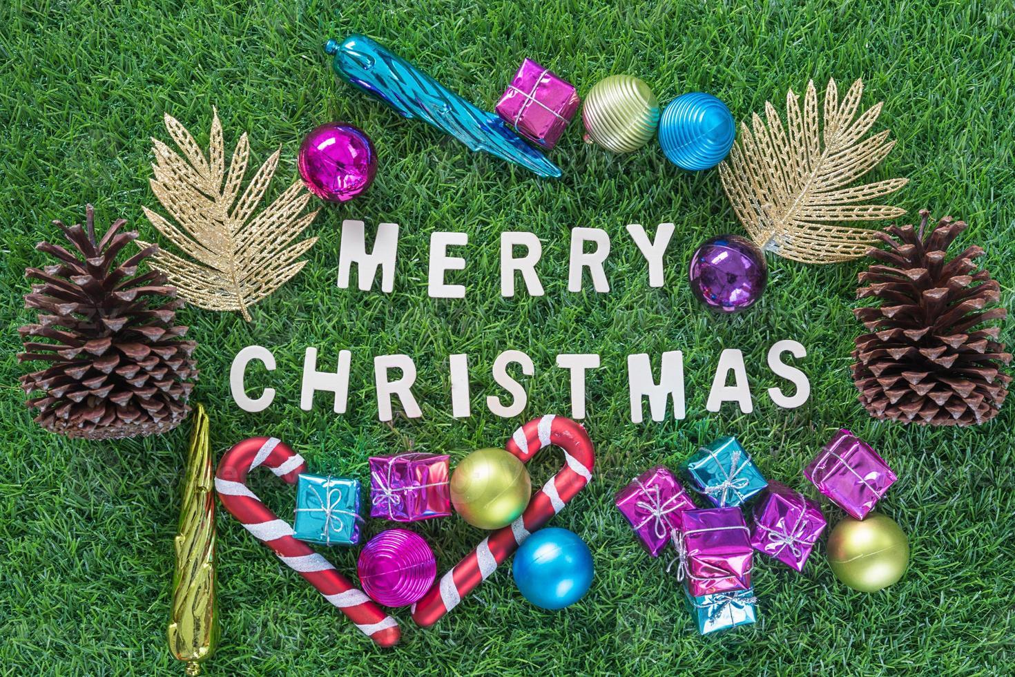 Christmas alphabet and decoration on green grass photo