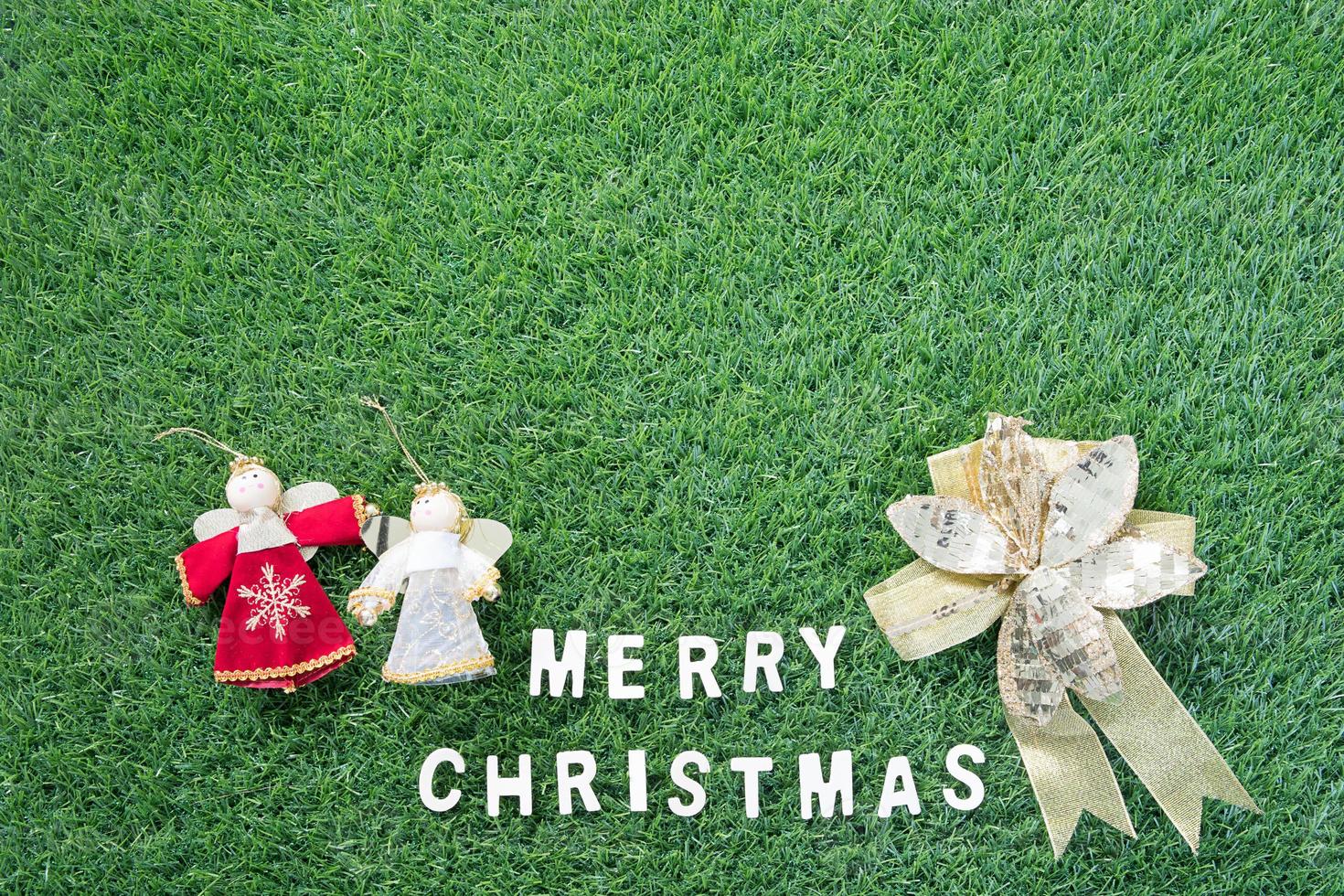 Christmas alphabet and decoration on green grass photo