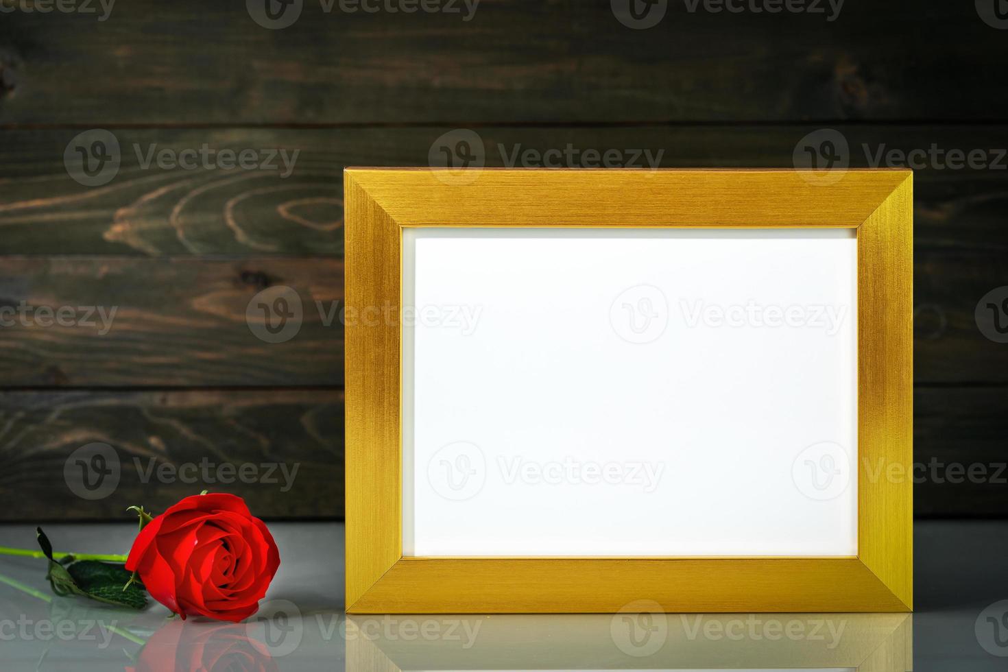 Picture mock up with golden frame on table with copy space photo