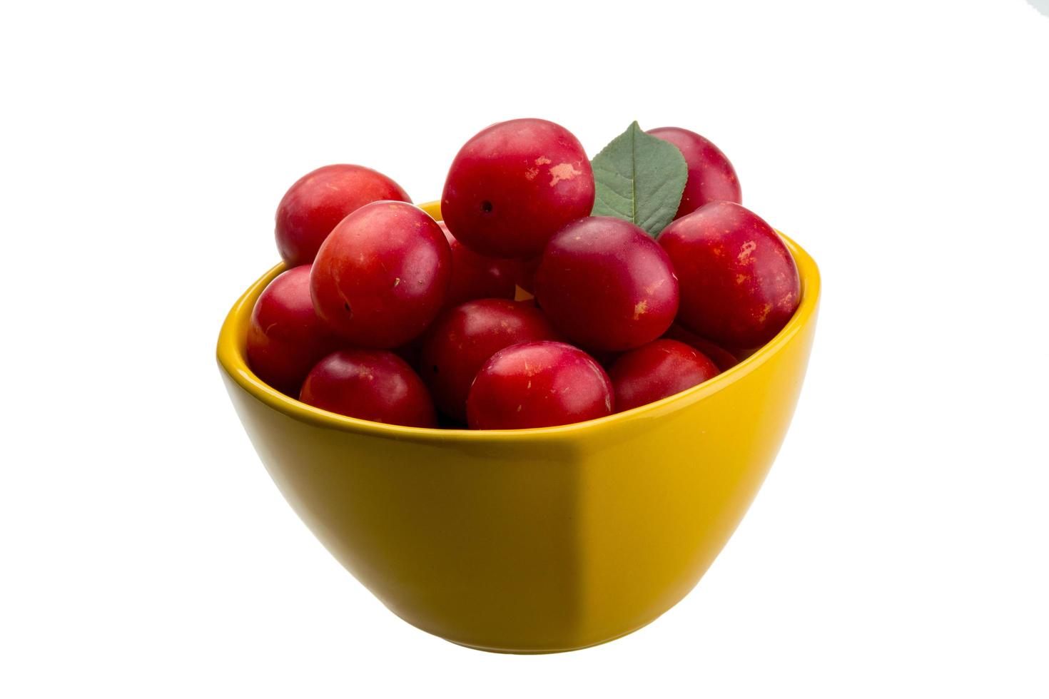 Damson plum in a bowl on white background photo
