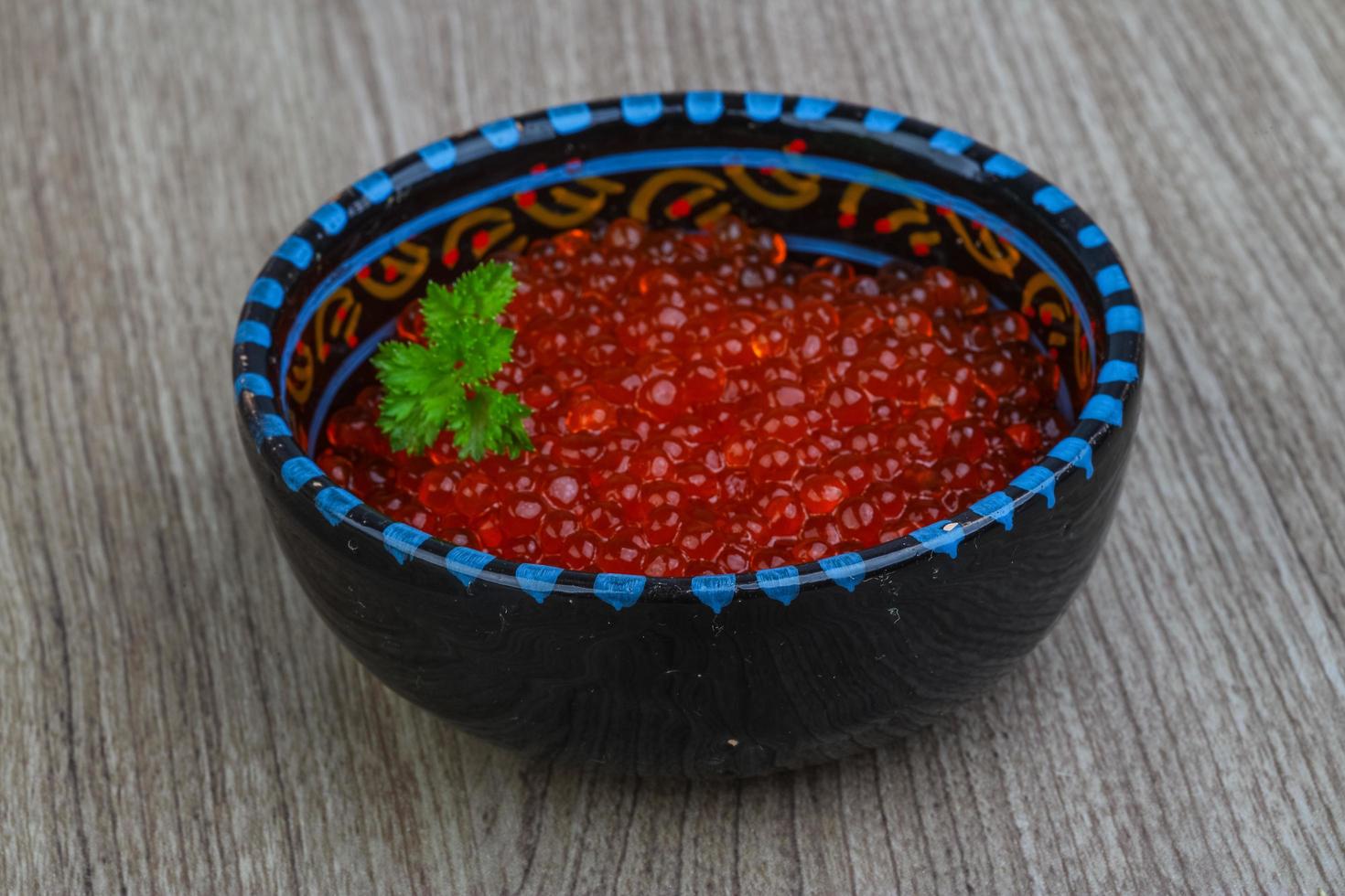 Red caviar on wood photo