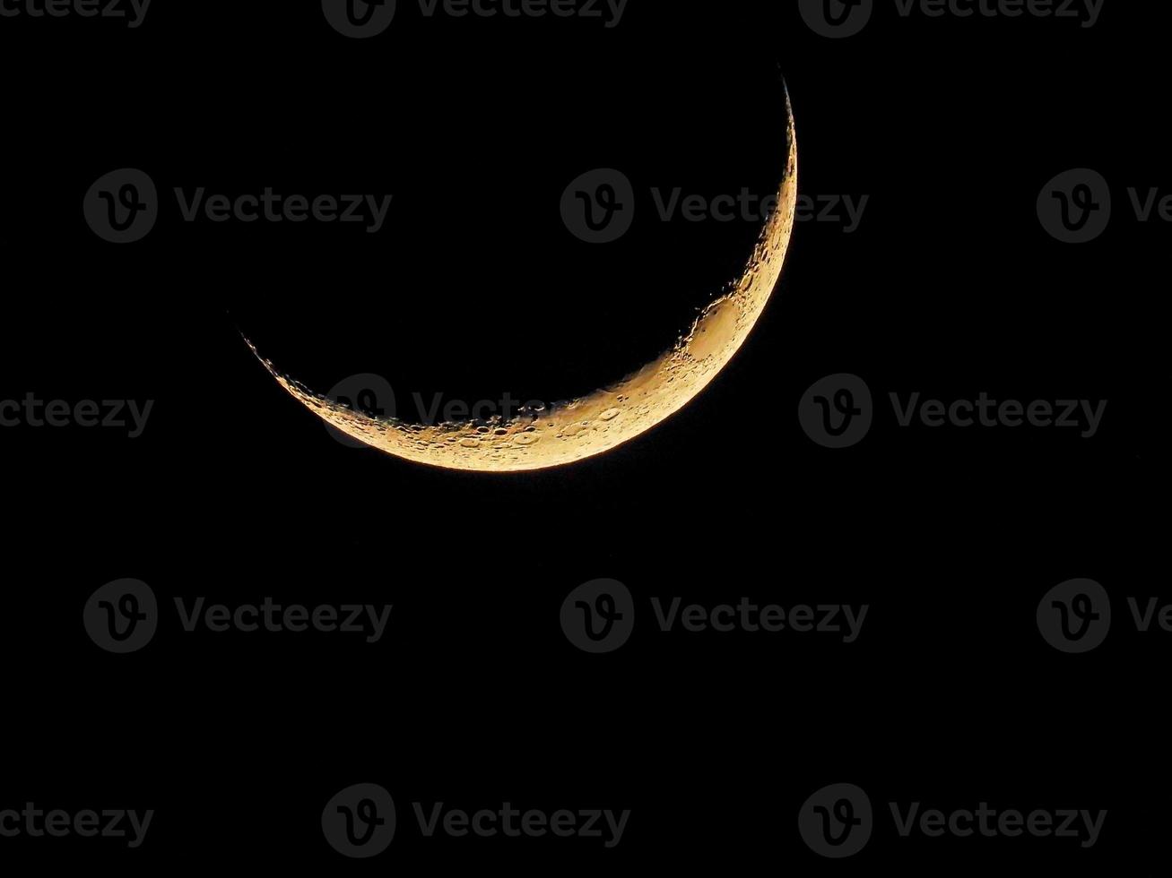 crescent moon in the dark sky photo