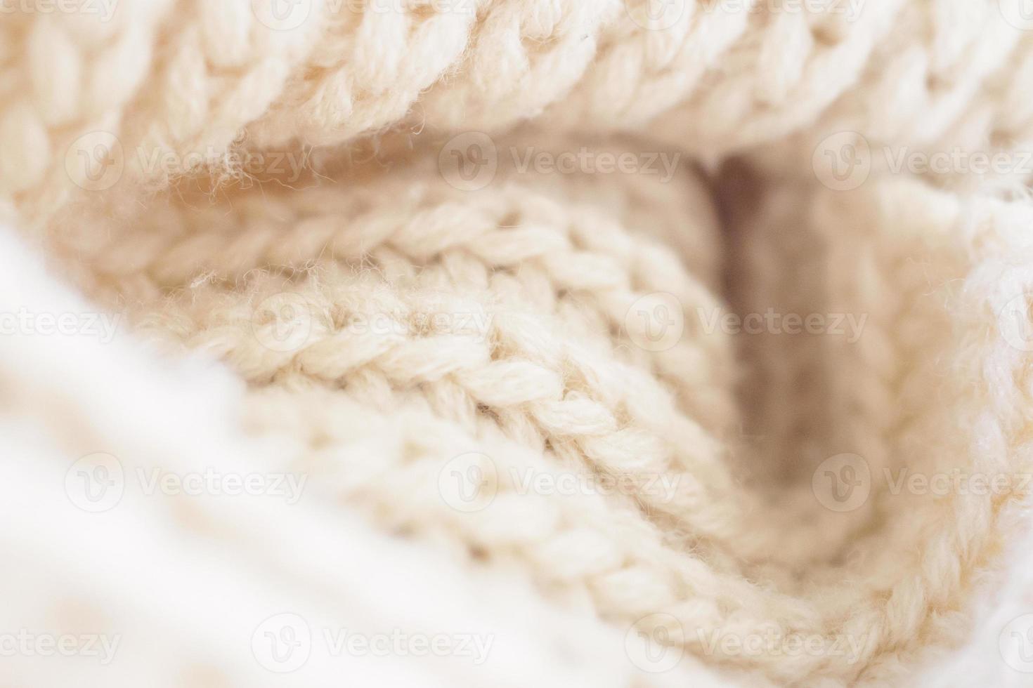 closeup beige knitted woolen fabric texture background photo